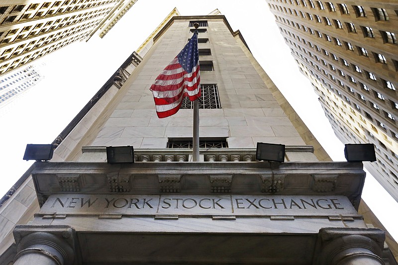 FILE - In this Friday, Nov. 13, 2015, file photo, the American flag flies above the Wall Street entrance to the New York Stock Exchange. U.S. stocks are mixed, Wednesday, Oct. 11, 2017, as household goods and health care companies move higher and banks and energy companies decline. (AP Photo/Richard Drew, File)