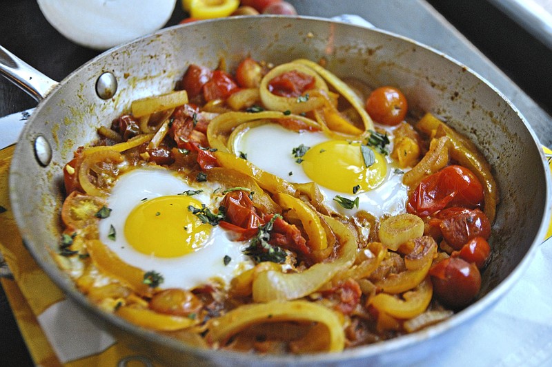 Golden Shakshuka is made with yellow bell peppers and yellow cherry tomatoes. 