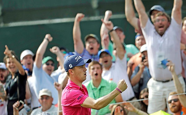 In this Aug. 13, 2017, file photo, Justin Thomas celebrates after chipping in for a birdie on the 13th hole during the final round of the PGA Championship at the Quail Hollow Club in Charlotte, N.C.