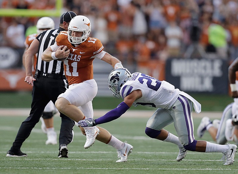 In this Oct. 7, 2017, file photo, Texas quarterback Sam Ehlinger (11) runs around Kansas State defensive back Denzel Goolsby (20) during the first half of an NCAA college football game, in Austin, Texas. With a tough running style that break tackles and drives defensive backs to the ground, Texas freshman quarterback Sam Ehlinger is sending a message to rival Oklahoma: these Longhorns are tougher than Texas teams of recent past past. 