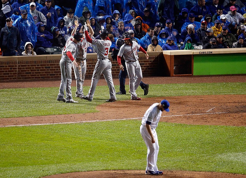 Washington Nationals' Michael Taylor (3) celebrates his grand slam as Chicago Cubs relief pitcher Wade Davis looks down during the eighth inning of Game 4 of baseball's National League Division Series, Wednesday, Oct. 11, 2017, in Chicago. 