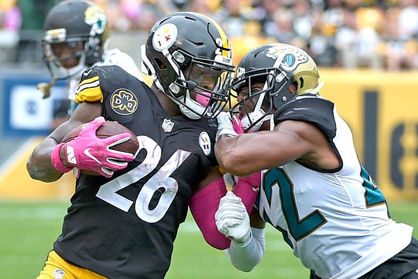 Jaguars safety Barry Church tries to tackle Steelers running back Le'Veon Bell during last Sunday's game in Pittsburgh.