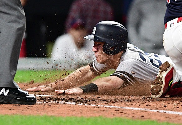 Todd Frazier of the Yankees slides home safely during the ninth inning of Wednesday's Game 5 of the AL Division Series against the Indians in Cleveland.