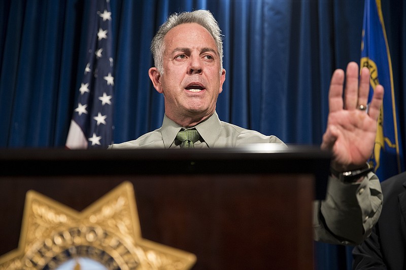FILE - In this Monday, Oct. 9, 2017 file photo, Clark County Sheriff Joe Lombardo discusses the Route 91 Harvest festival mass shooting at the Las Vegas Metropolitan Police Department headquarters in Las Vegas. On Monday, Lombardo said Paddock shot and wounded the security guard outside his door and opened fire through his door around 9:59 p.m. - six minutes before shooting into the crowd. That was a different account from the one police gave last week: that Paddock shot the guard, Jesus Campos, after unleashing his barrage of fire on the crowd. (Erik Verduzco/Las Vegas Review-Journal via AP, File)