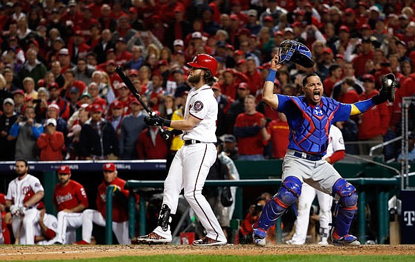 Cubs catcher Willson Contreras begins to celebrate after Bryce Harper of the Nationals struck out swinging for the final out in Thursday night's NLDS Game 5 in Washington. The Cubs advanced to the NLCS with a 9-8 win.