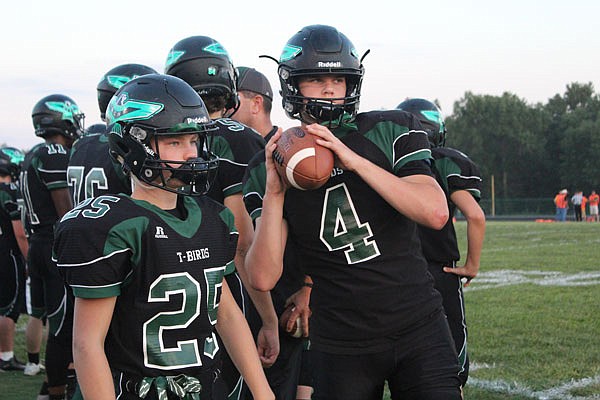 North Callaway quarterback Tully Thomsen (right) warms up before the Thunderbirds' game against Wright City last month in Kingdom City.