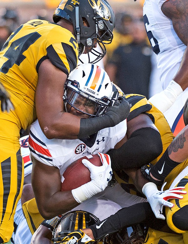 Auburn running back Kerryon Johnson is wrapped up by Missouri's Terez Hall as he tries to squeeze toward the goal line during the first quarter of a game last month at Faurot Field.