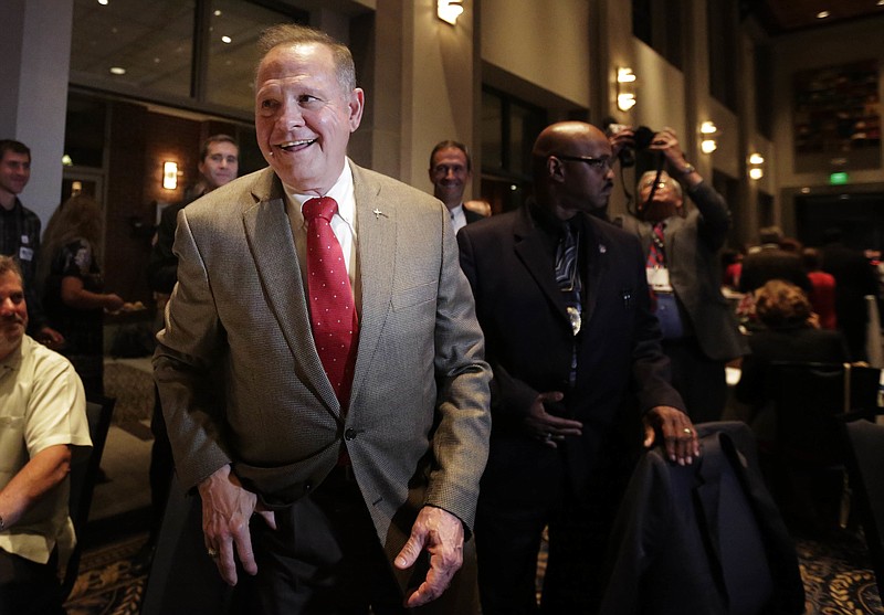 FILE- In this Sept. 26, 2017, file photo, U.S. Senate candidate Roy Moore greets supporters before his election party in Montgomery, Ala. President Donald Trump’s former chief strategist Steve Bannon is boosting multiple challengers to GOP incumbents and the party’s preferred candidates in next year’s midterm elections(AP Photo/Brynn Anderson, File)