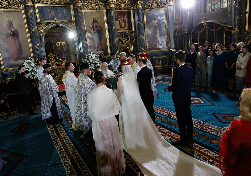 Serbian Orthodox Church Patriarch Irinej, center, performs the wedding ceremony of Prince Philip Karadjordjevic, of the dethroned Serbian royals, and his wife Danica Marinkovic in Belgrade's Congregational church in Serbia, Saturday, Oct. 7, 2017. Prince Philip is one of the sons of Crown Prince Aleksandar Karadjordjevic, the heir to Serbia's now-defunct throne. 