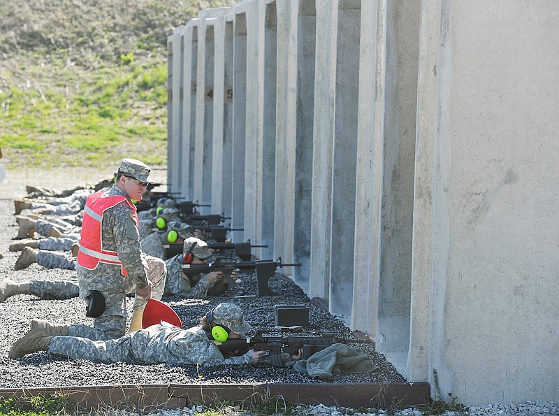 In this April 7, 2017 photo, Sgt. Ariel Dinwiddie watches as one of his soldiers, a member of the 835th Combat Sustainment Support Battalion based at the Blue Armory in Jefferson City, fires her weapon through the tube at MoNAG Headquarters. This group was the first to use the improved facility at the firing range at the Ike Skelton Training Site.