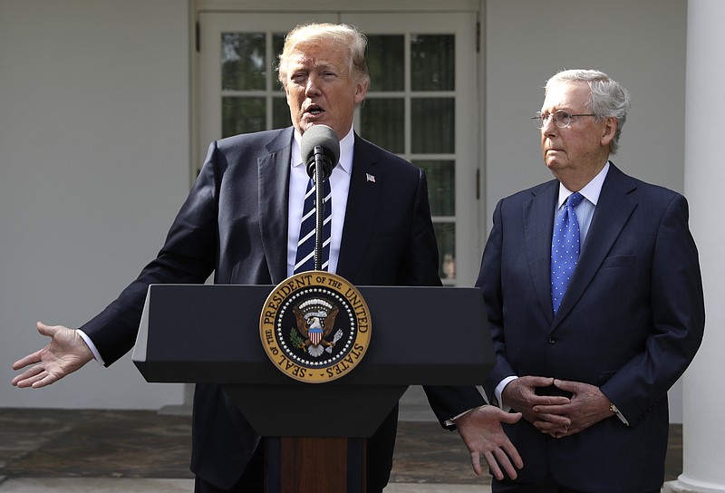 President Donald Trump answers questions with Senate Majority Leader Mitch McConnell, R-Ky., in the Rose Garden at the White House, Monday, Oct. 16, 2017, in Washington. (AP Photo/Evan Vucci)
