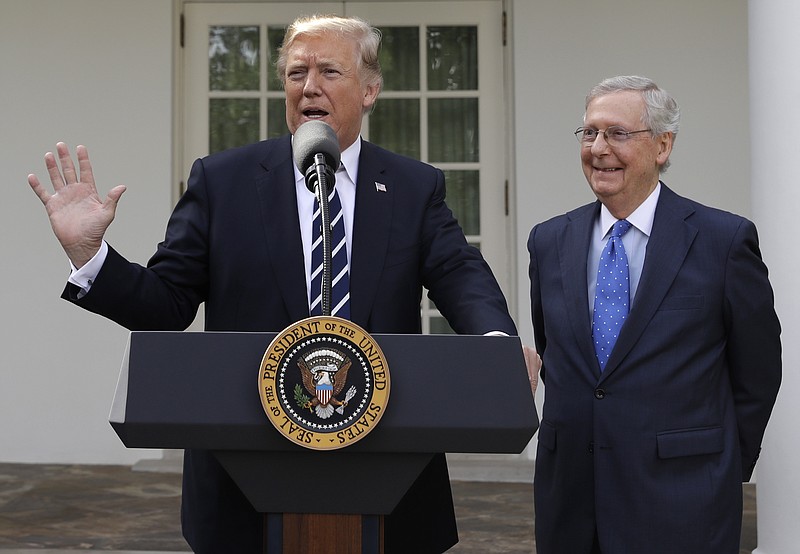 President Donald Trump answers questions with Senate Majority Leader Mitch McConnell, R-Ky., in the Rose Garden after their meeting at the White House, Monday, Oct. 16, 2017, in Washington. (AP Photo/Evan Vucci)
