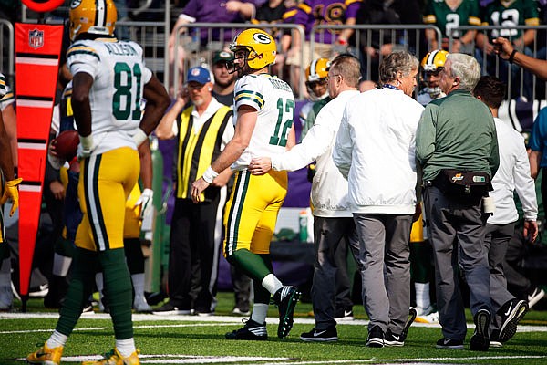 Packers quarterback Aaron Rodgers walks off the field after being injured in Sunday's game against the Vikings in Minneapolis.