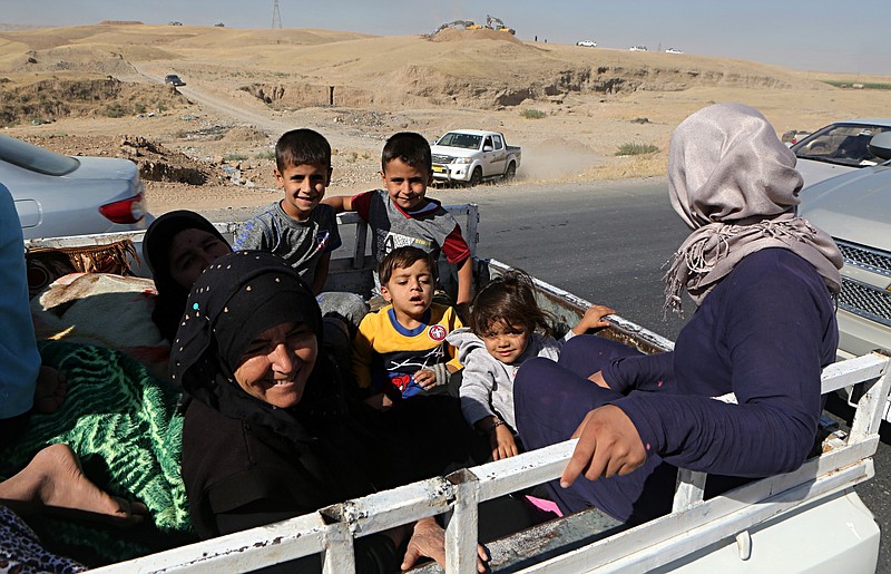 People return back to Kirkuk, 290 kilometers (180 miles) north of Baghdad, Iraq, Tuesday, Oct. 17, 2017. Thousands of civilians are streaming back to Kirkuk, a day after fleeing as Iraqi troops pushed Kurdish forces out of the disputed oil-rich city. (AP Photo/Khalid Mohammed)