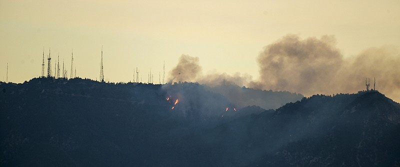 A fire burns near the summit of  Mount Wilson early Tuesday, Oct. 17, 2017, northeast of Los Angles.  Firefighters on the ground and in the air raced to protect the Mount Wilson Observatory and nearby communications towers from a growing brush fire.   (David Crane/Los Angeles Daily News via AP)