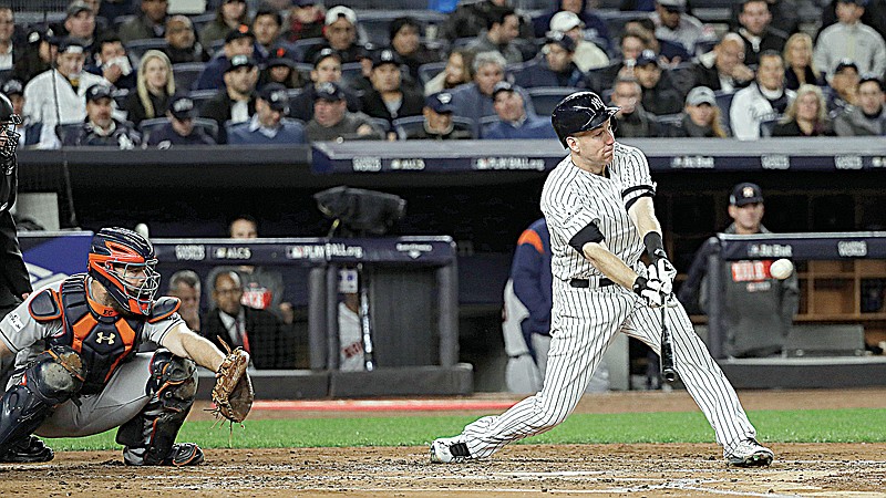 New York Yankees' Todd Frazier hits a three-run home run Monday during the third inning of Game 3 of the American League Championship Series against the Houston Astros in New York. The Yankees won, 8-1.