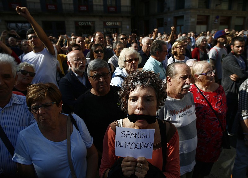 People protest the National Court's decision to imprison civil society leaders without bail Tuesday, Oct. 17, 2017, in front of the Palau Generalitat in Barcelona, Spain. Protesters were gathering for a fresh round of demonstrations in Barcelona Tuesday to demand the release of two leaders of Catalonia's pro-independence movement who were jailed in a sedition probe. 