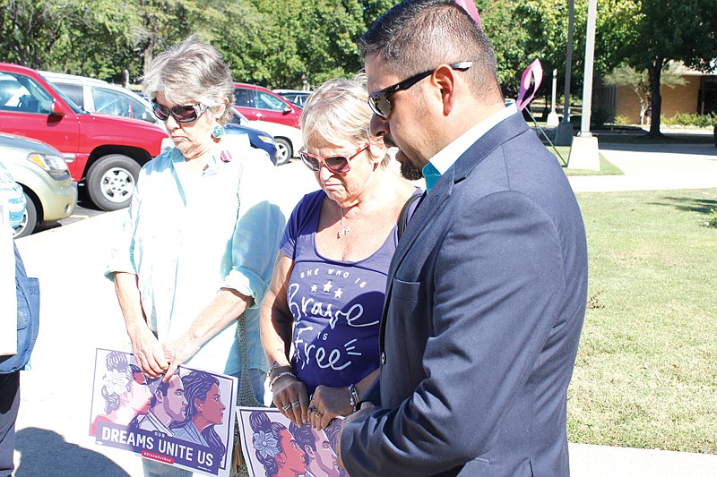 Eladio Puente, right, pastor of Primeria Iglesia Bautista Hispana de Texarkana, leads Jan Clem, left, and Jodi O'Connell in prayer Monday outside United States Rep. John Ratcliffe's office on the campus of Texarkana College. As part of a nationwide event organized by MoveOn.org, six of Ratcliffe's constituents including Clem and O'Connell presented a petition to a Ratcliffe staff member. Signed by about 120 people, the petition calls for Ratcliffe's support of a Dream Act, legislation that would protect undocumented immigrants brought to the U.S. as children.

