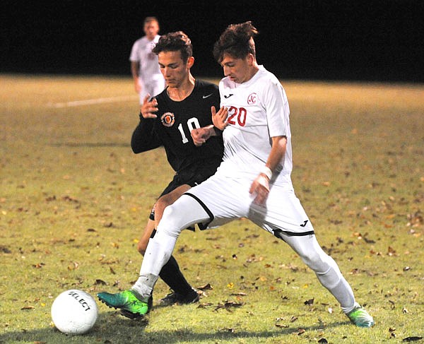 Jefferson City's Max Allen (right) tries to keep the ball away from Waynesville's Joey Cartwright during Monday night's match at the 179 Soccer Park. 