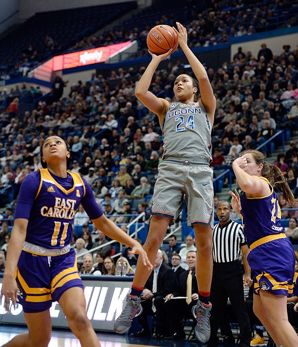 In this Jan. 4 file photo, Connecticut's Napheesa Collier (center) shoots over East Carolina's Raven Johnson (left) in the first half of a game in Hartford, Conn.