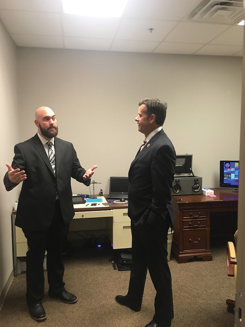 Cody Sartor, chief criminal investigator for Cass County District Attorney's Office, talks to U.S. Rep. John Ratcliffe, R-Texas, about information he learned on cyber crimes at the National Computer Forensics Institute.