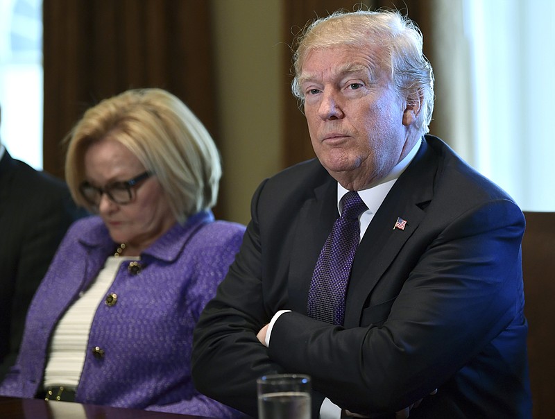 President Donald Trump, right, sitting next to Sen. Claire McCaskill, D-Mo., left, speaks during a meeting with members of the Senate Finance Committee and members of the President's economic team in the Cabinet Room of the White House in Washington, Wednesday, Oct. 18, 2017. (AP Photo/Susan Walsh)