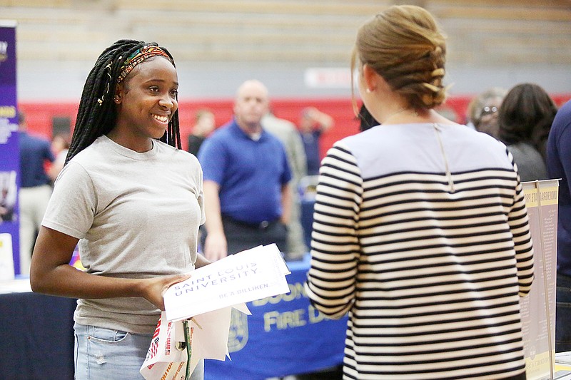 Keziah Madison, left, speaks with a Saint Louis University representative Tuesday during the career and college fair at Jefferson City High School.