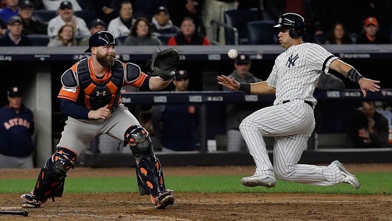 New York Yankees' Gary Sanchez is forced out at home as Houston Astros catcher Brian McCann takes the throw during the eighth inning of Game 4 of baseball's American League Championship Series Tuesday, Oct. 17, 2017, in New York. 