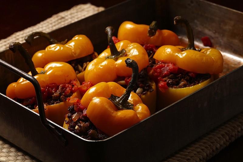 Serbian style stuffed red bell peppers are filled with ground beef, onion, peppers, garlic, pine nuts, rice and raisins.