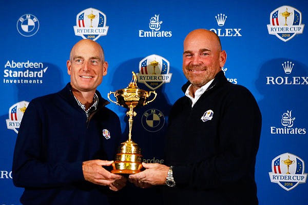 U.S. Ryder Cup captain Jim Furyk (left) and Europe's Ryder Cup captain Thomas Bjorn hold the trophy during a media conference Tuesday in Paris.