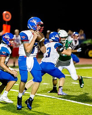 California quarterback Bryant Davis looks for an open receiver downfield during a game against the Blair Oaks Falcons earlier this season in Wardsville.