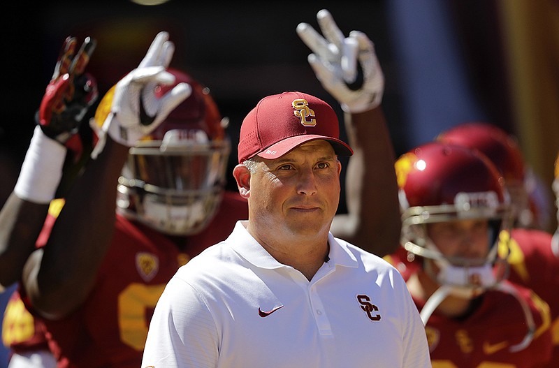 In this Oct. 8, 2016, file photo, Southern California coach Clay Helton leads his players onto the field before an NCAA college football game against Colorado in Los Angeles. A team with two losses has yet to make the College Football Playoff. At some point it will probably happen, but for now it is safe to assume that a second loss is a big problem. So for No. 11 USC and No. 13 Notre Dame, Saturday's game is sort of a playoff eliminator. 