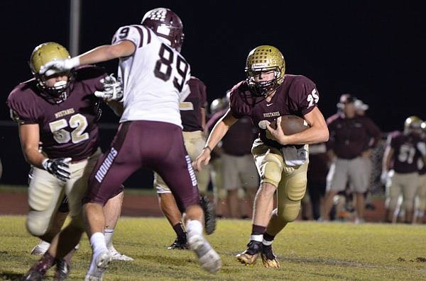 Dawson Brandt of Eldon takes off for a first down during a game this season against School of the Osage.