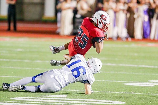 Noah Jahr of Jefferson City is brought down by Sam Tatum of Rockhurst during last Friday night's game at Adkins Stadium.