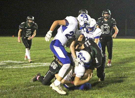 North Callaway sophomore defensive end Bradley Berry (11) and senior inside linebacker Tanner Pezold (56) take Montgomery County senior quarterback Aubrey Nelson to the ground in the Thunderbirds' 55-21 win last week in Kingdom City.