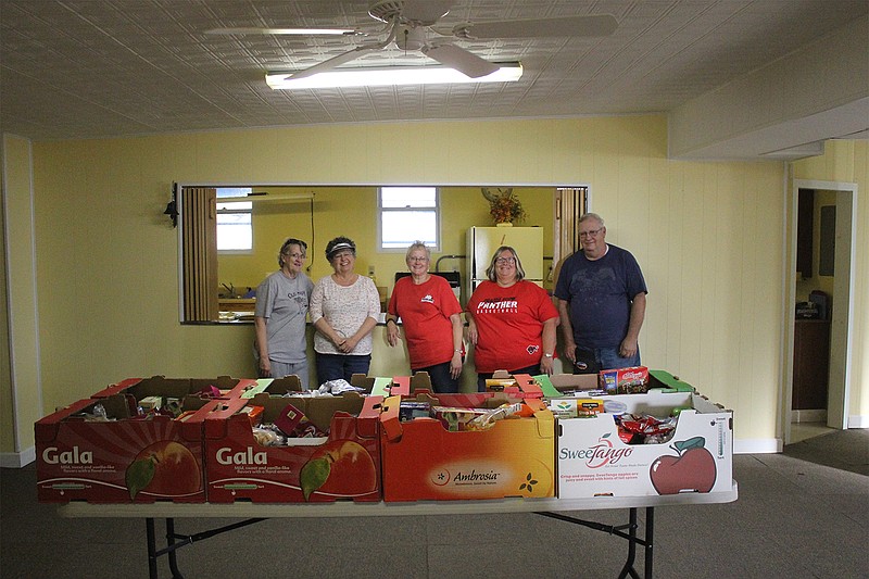 <p>Democrat photos/Kevin Labotka</p><p>Volunteers at the Mustard Seed food pantry help people in need.</p>