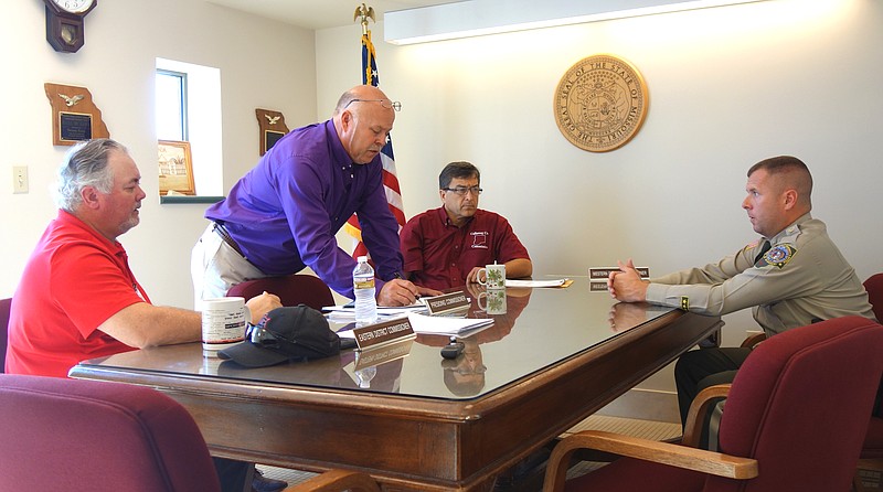 Callaway County Sheriff Clay Chism, right, explains the need for a second domestic violence investigator to Callaway County Commissioners Randy Kleindienst, left, Gary Jungermann and Roger Fischer. The county's current domestic violence investigator is partially paid by the federal Violence Against Women Act grant.