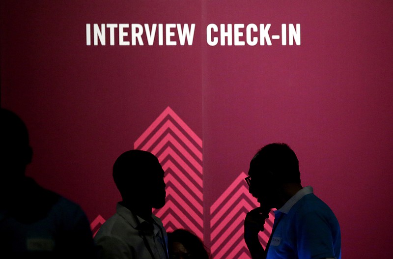 FILE - In this Friday, May 19, 2017, file photo, job seekers chat during the Opportunity Fair and Forum employment event in Dallas. On Friday, Oct. 20, 2017, the Labor Department reports on state unemployment rates for September. (AP Photo/LM Otero, File)