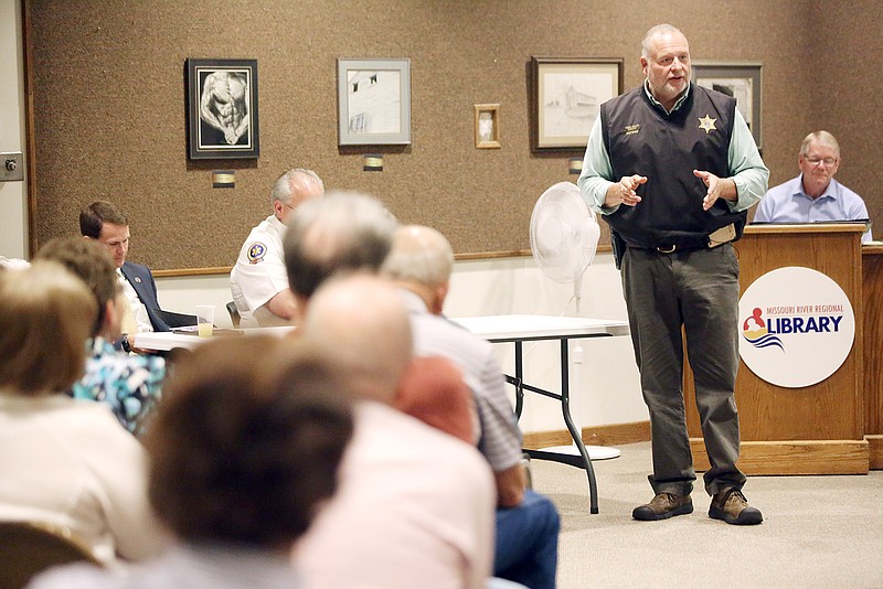 Retired sheriff Greg White speaks Thursday during "Protecting our Homeland: First Responders Post-9/11" at the Missouri River Regional Library. During the panel, first responders addressed challenges of current day public service.