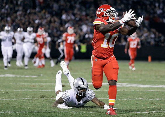 Chiefs wide receiver Tyreek Hill catches a touchdown past Raiders cornerback David Amerson during the first half of Thursday night's game in Oakland, Calif.