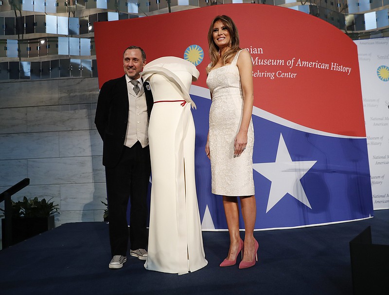 First lady Melania Trump donates her inaugural gown, designed by Herve Pierre, left, to the First Ladies' Collection at the Smithsonian's National Museum of American History on Friday, Oct. 20, 2017, during a ceremony in Washington.