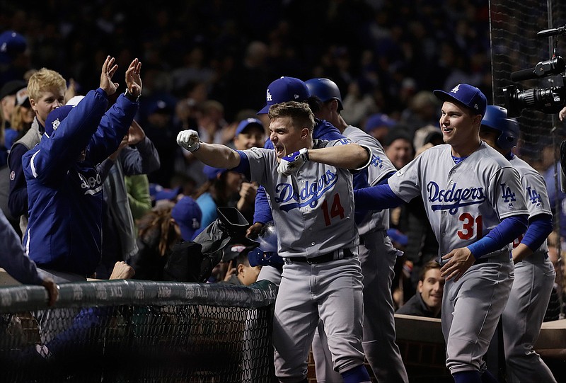 Los Angeles Dodgers' Enrique Hernandez (14) celebrates after hitting a grand slam during the third inning of Game 5 of baseball's National League Championship Series against the Chicago Cubs, Thursday, Oct. 19, 2017, in Chicago. 