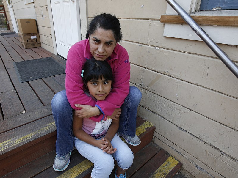 Wilma Illanes and her daughter Gabriela Cervantes, 8, pose Wednesday, Oct. 18, 2017, in Sonoma, Calif. Illanes and her family had to evacuate from there home as a massive wildfire swept through the area last week. While their home was sparred, Illanes, who is a baby sitter, and her husband, who is a landscaper, were both out of work for a work causing them to seek assistance due to the hardship.  AP Photo/Rich Pedroncelli)