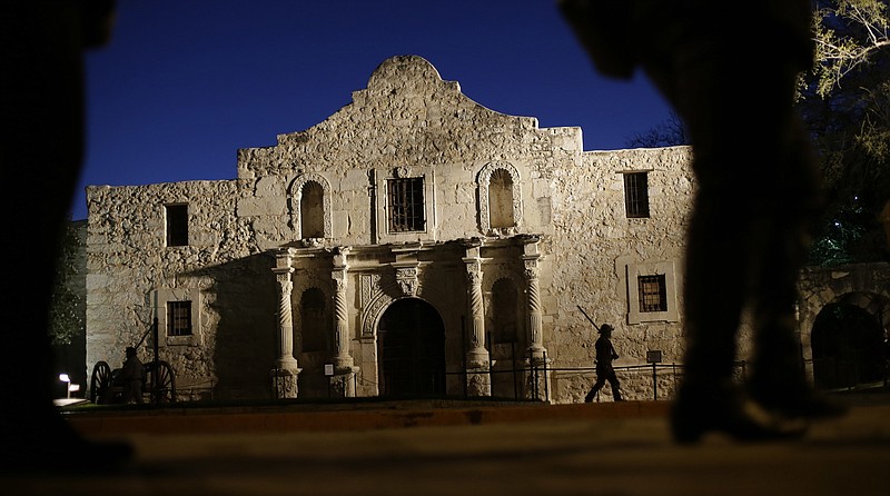 In this March 6, 2013 file photo, Dan Phillips, a member of the San Antonio Living History Association, patrols the Alamo during a pre-dawn memorial ceremony to remember the 1836 Battle of the Alamo and those who fell on both sides, in San Antonio. Texas Land Commissioner George P. Bush is overseeing a 7-year, $450 million revamp of the Alamo, where 189 independence fighters were killed in 1836. That includes restoration of historical structures and building a new museum and visitors' center. But some conservatives worry that the importance of the battle for the Alamo will be marginalized by "political correctness," with the overhaul sanitizing less-desirable aspects of participants' history, including that some were slaveholders. 