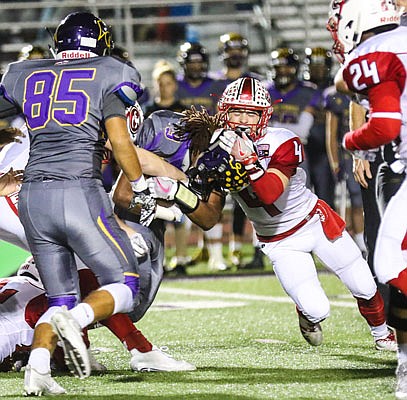 Jefferson City safety Tyler Bise tackles Blue Springs running back Aveion Bailey during the first half of Friday night's district game in Blue Springs.