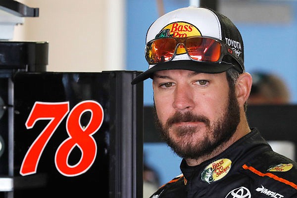 Martin Truex Jr. waits in the garage before Friday's practice for a NASCAR Monster Cup race at Kansas Speedway in Kansas City, Kan