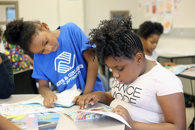 T'Qyra Sessioa, 8, front, and Marli Goodman, 8, read after school Friday, Oct. 20, 2017 at the Boys & Girls Club of Jefferson City. The club recently received a $1.5 million grant for STEM programs.