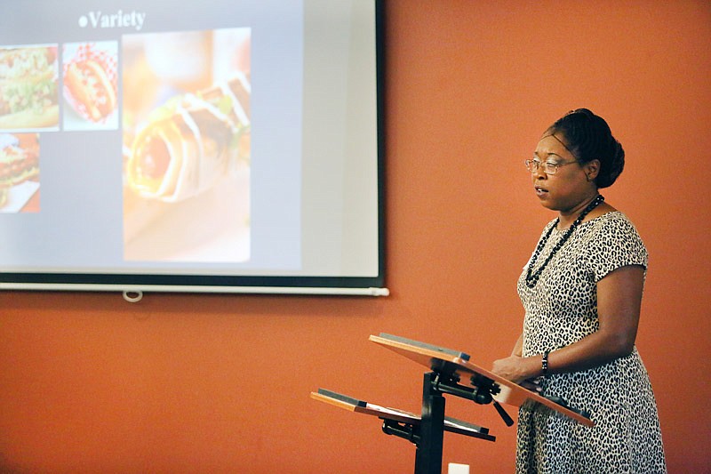 Tamisha Eldridge pitches her business, "Dream Dogs," in front of
a group of judges Saturday, Oct. 21, 2017 during Pitch It & Win It at the Capital
Event Center in Jefferson City. The competition offered participants a chance to
pitch their business plans for a cash prize.