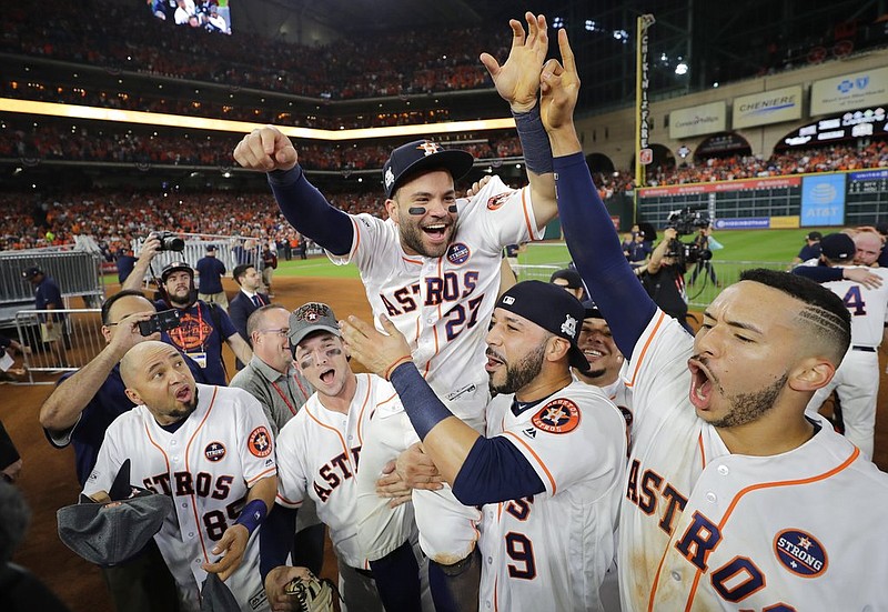 Houston Astros' Jose Altuve is lifted by teammates after Game 7 of baseball's American League Championship Series against the New York Yankees Saturday, Oct. 21, 2017, in Houston. The Astros won 4-0 to win the series. 