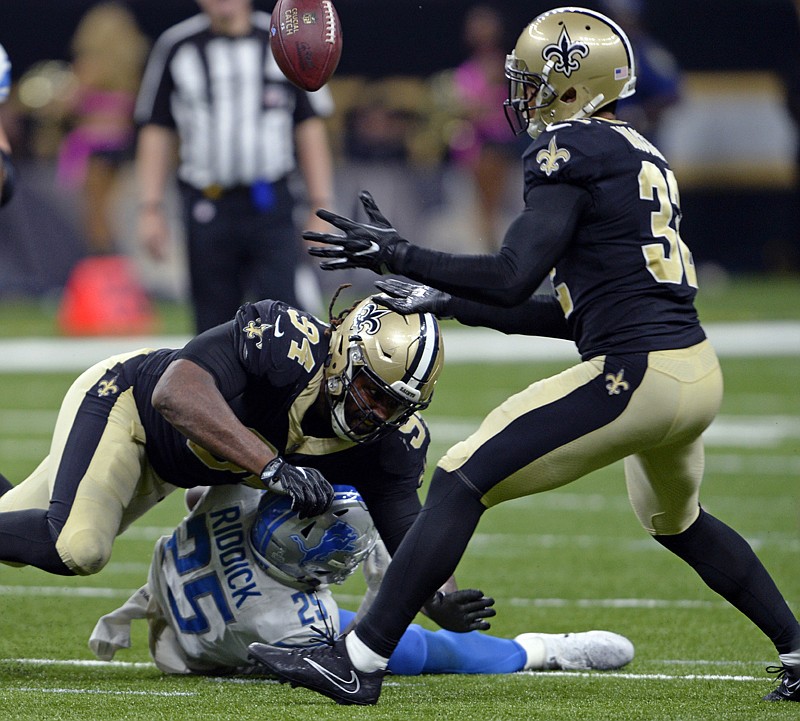New Orleans Saints defensive end Cameron Jordan (94) forces Detroit Lions running back Theo Riddick (25) to lose the football on a pass play, as Saints strong safety Kenny Vaccaro (32) intercepts in the second half of an NFL football game Oct. 15 in New Orleans. An improved defense that forced five turnovers helped New Orleans win its third straight game following an 0-2 start. The Saints take on the Green Bay Packers on Sunday. 